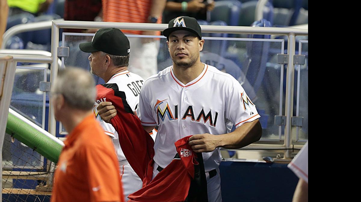
GIANCARLO STANTON sostiene la camisa de estelar que le fue entregada el 10 de julio en el parque de los Marlins.
