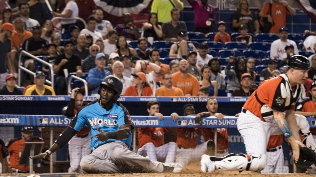 YORDAN ALVAREZ se desliza en la goma para anotar una carrera en el Juego de las Estrellas del Futuro el 9 de julio en el Marlins Park.