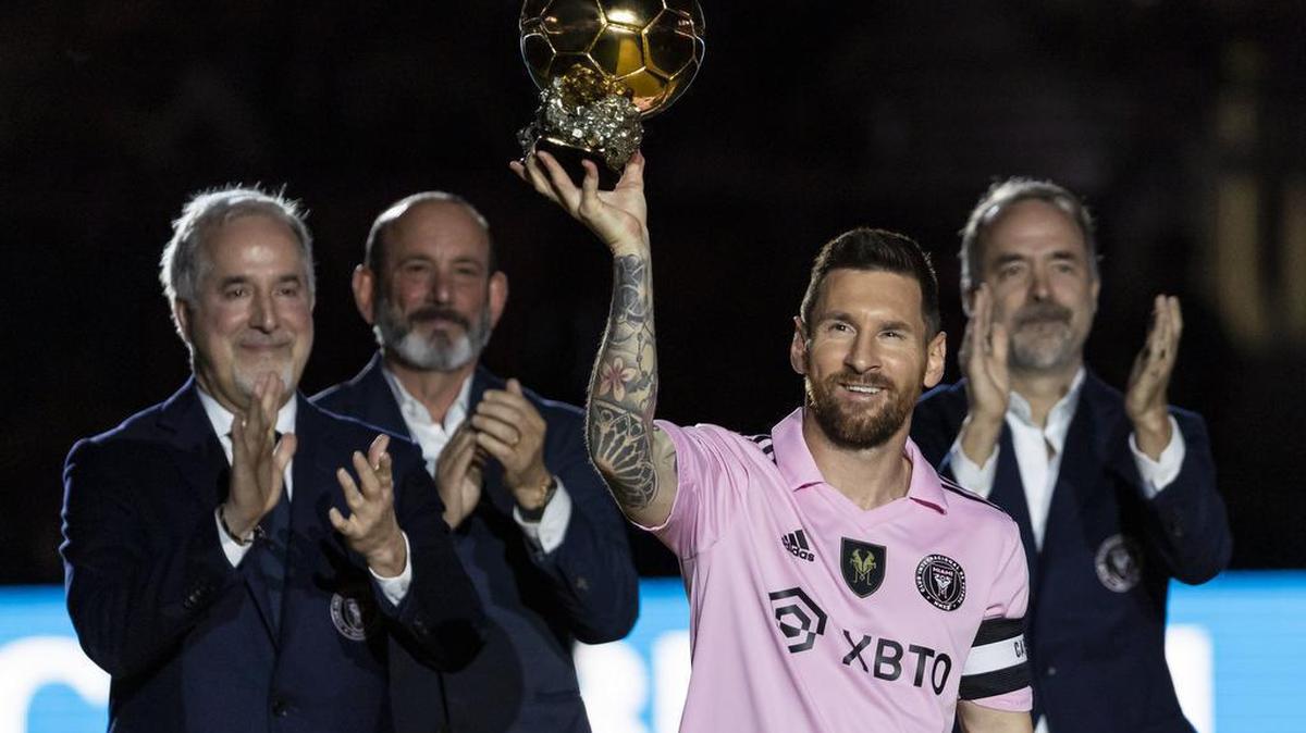 Inter Miami forward Lionel Messi (10) holds the Ballon d’Or during the opening ceremonies of his Noche d’Or soccer match against NYCFC at DRV PNK Stadium on Friday, Nov. 10, 2023, in Fort Lauderdale, Fla. From left to right: He is flanked by Inter Miami Co-owner Jorge Mas, MLS Commissioner Don Garber and Inter Miami Co-owner Jose Mas during the event.