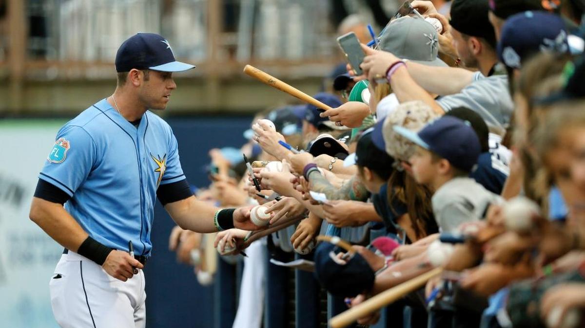Evan Longoria, de los Rays de Tampa Bays, firma autógrafos, el sábado en Port Charlotte, Fla.