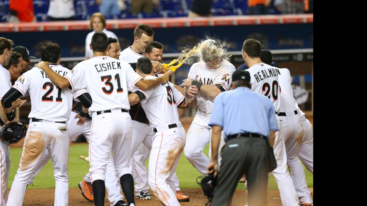 
Los jugadores de los Marlins celebran con Justin Bour después de que el primera base disparara el jonrón que dejó al campo a los Gigantes en el noveno inning, el miércoles 1ro de julio del 2015 en Miami.

