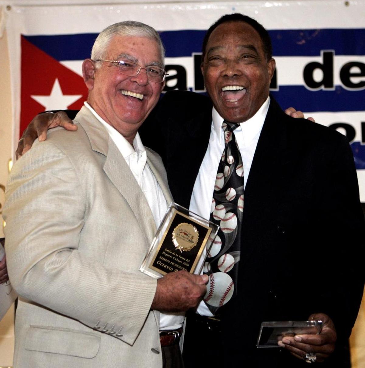 Octavio "Cookie" Rojas (izq.) y Tony Taylor posan después de recibir una placa en el Salón de la Fama del Deporte Cubano, el 29 de junio de 2006.