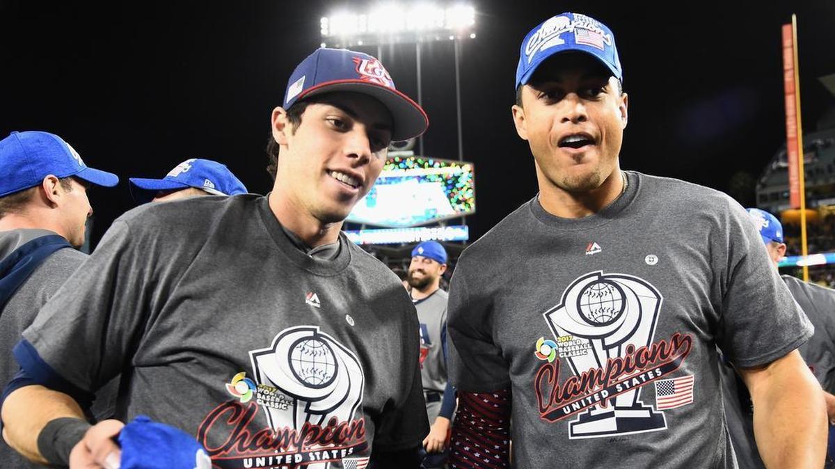 CHRISTIAN YELICH y Giancarlo Stanton (d) celebran el triunfo de Estados Unidos en el Clásico Mundial sobre la grama del Dodger Stadium.