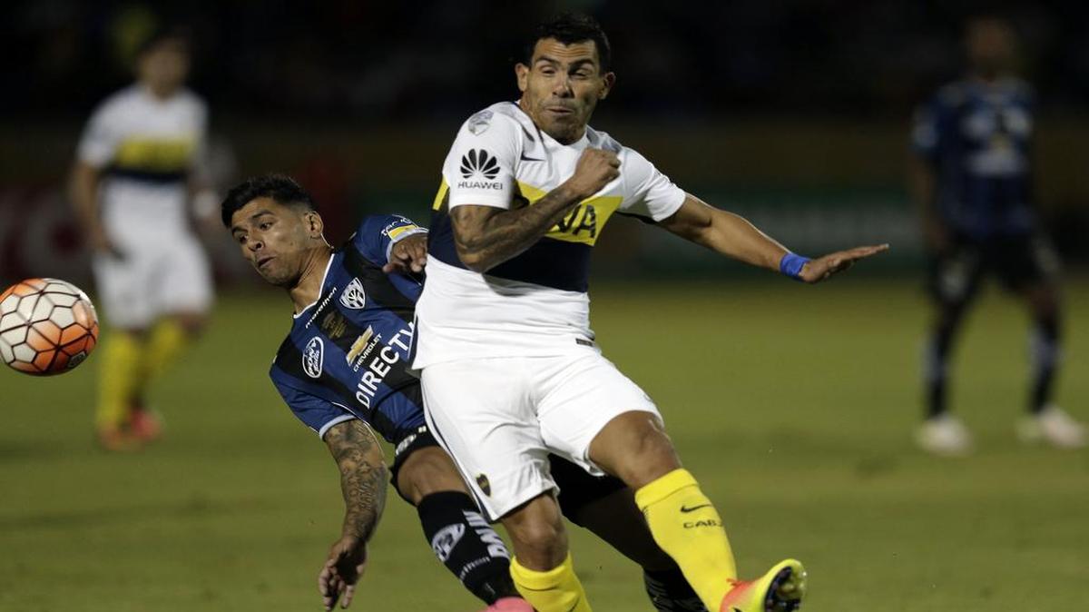 Carlos Tevez (der.), de Boca Juniors, disputa la bola con Emiliano Tellechea, de Independiente del Valle, en el partido de la ida de las semifinales de la Copa Libertadores, en Quito, Ecuador, el 7 de julio del 2016.
