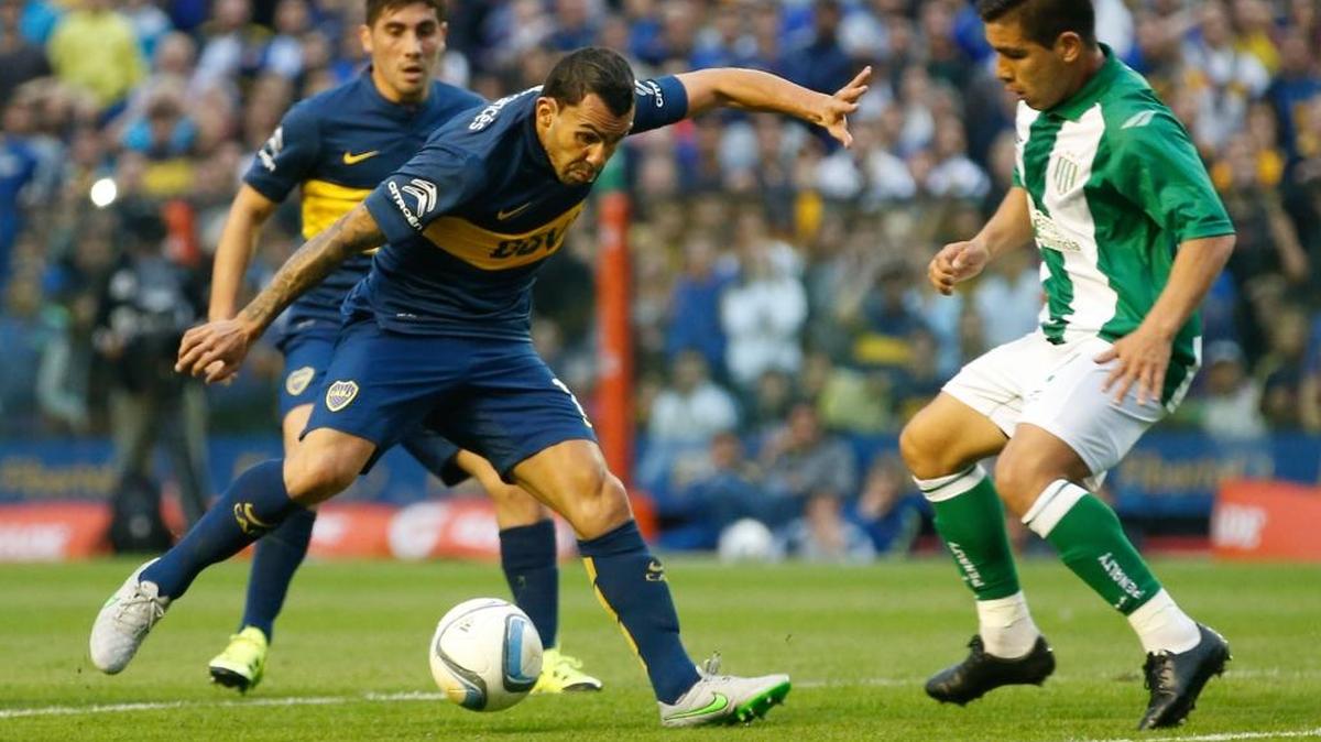 
El astro de Boca Juniors Carlos Tevez trata de burlar a un defensa de Banfield en la goleada dominical.
