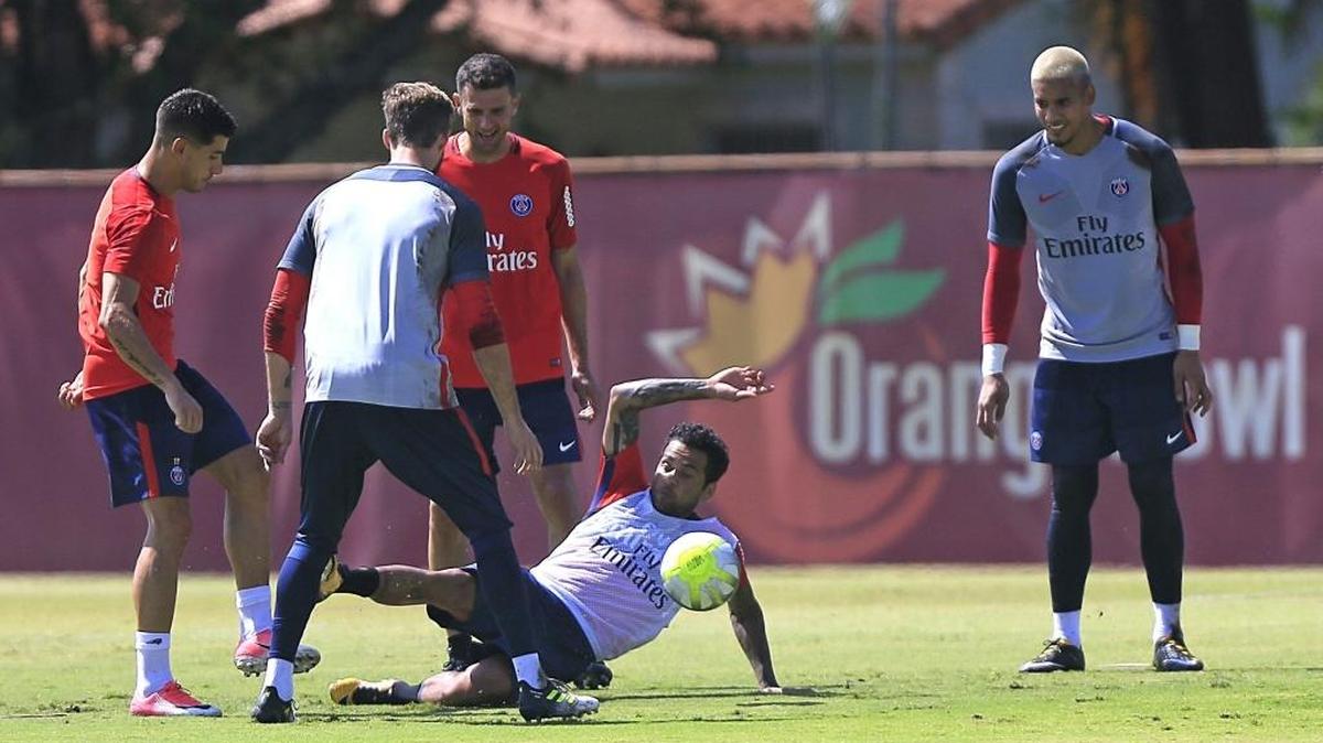 Desde el suelo, Dani Alves trata de recuperar una bola en la práctica de Paris Saint-Germain, el lunes en la cancha de Barry University en Miami.