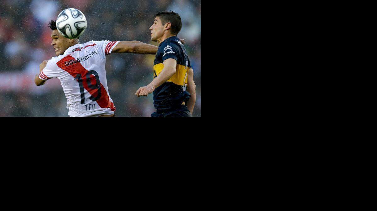 
Teófilo Gutiérrez, de River Plate (Izq.) cabecea el balón ante Cristian Erbes, de Boca Juniors, el 5 de octubre del 2014.


