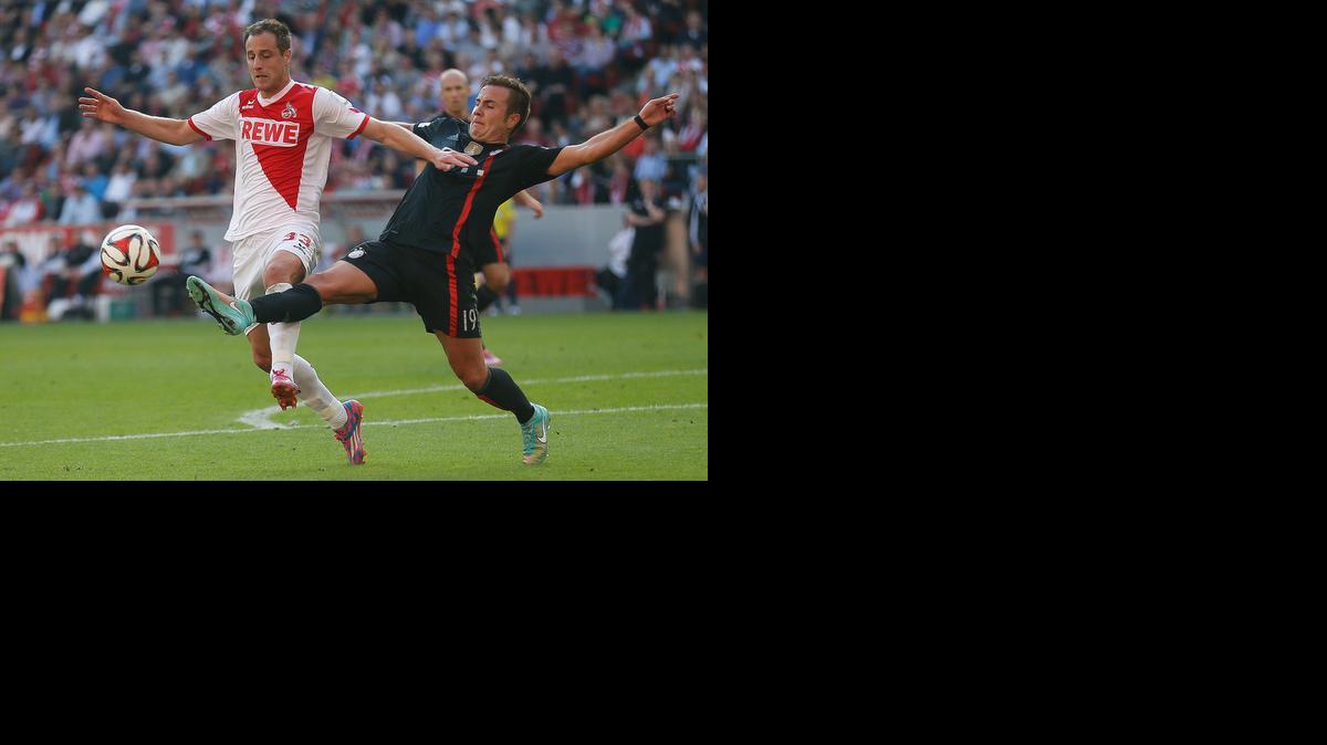 
Mario Gotze, del Bayern, puntea el balón ante el jugador del colonia Matthias Lehmann.


