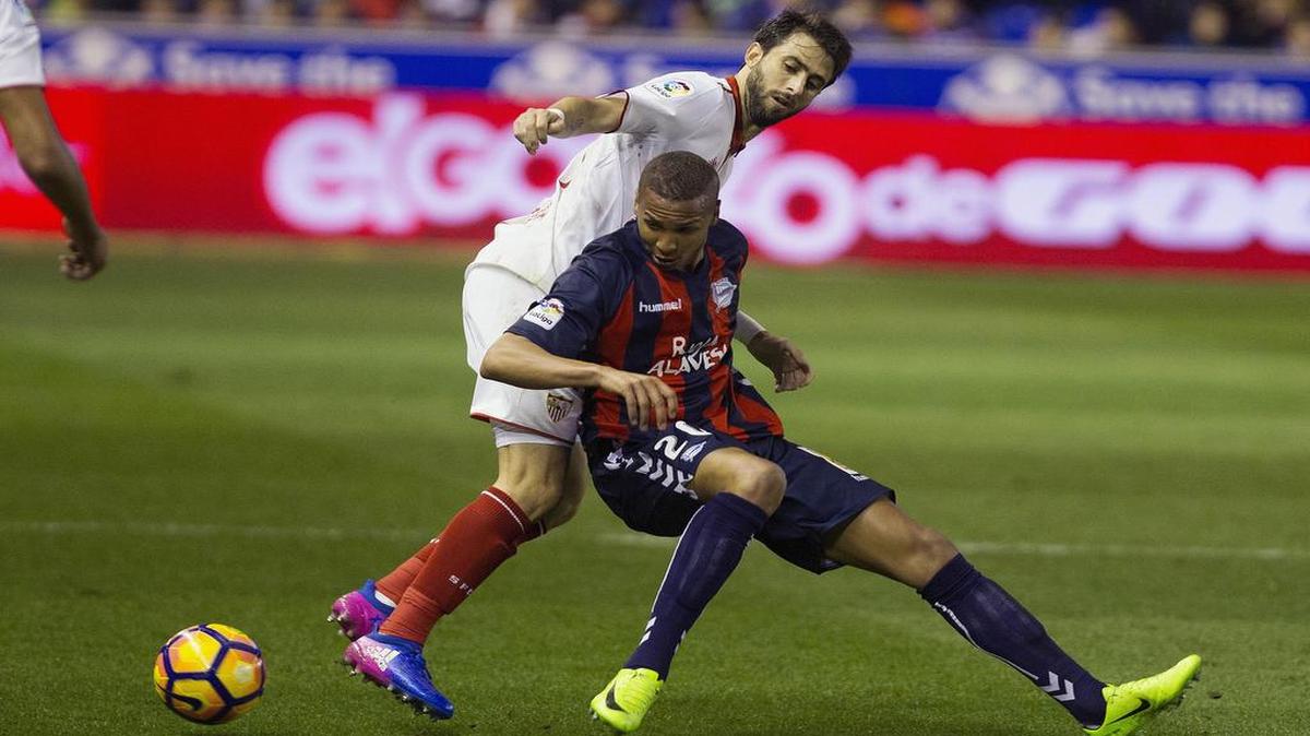 El defensa argentino del Sevilla, Nico Pareja (izq.) lucha por el balón con delantero brasileño Deyverson Silva, del Alavés, durante el partido correspondiente a la veintiseisava jornada de la liga española, celebrado el 6 de marzo del 2017.