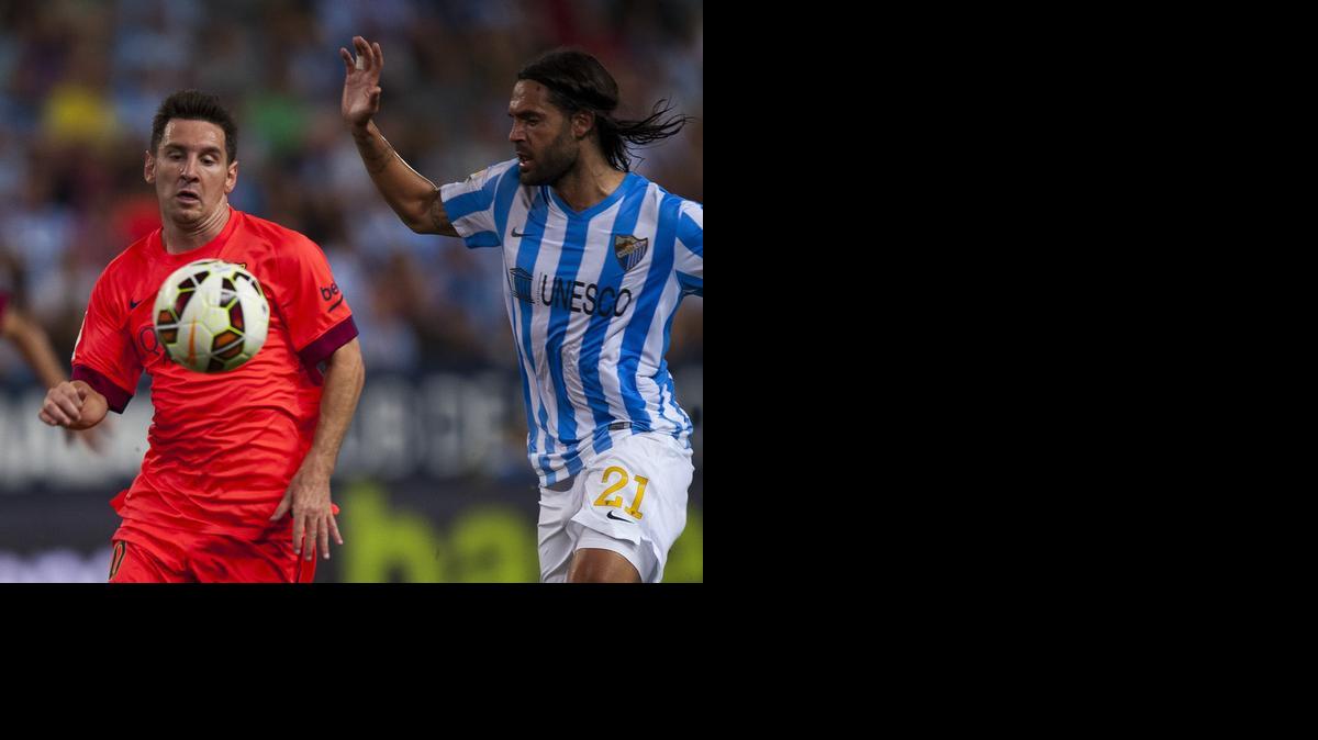 
Lionel Messi (izq.) disputa el balón con Sergio Sánchez, en el partido entre Barcelona y Málaga, el miércoles en la liga española.


