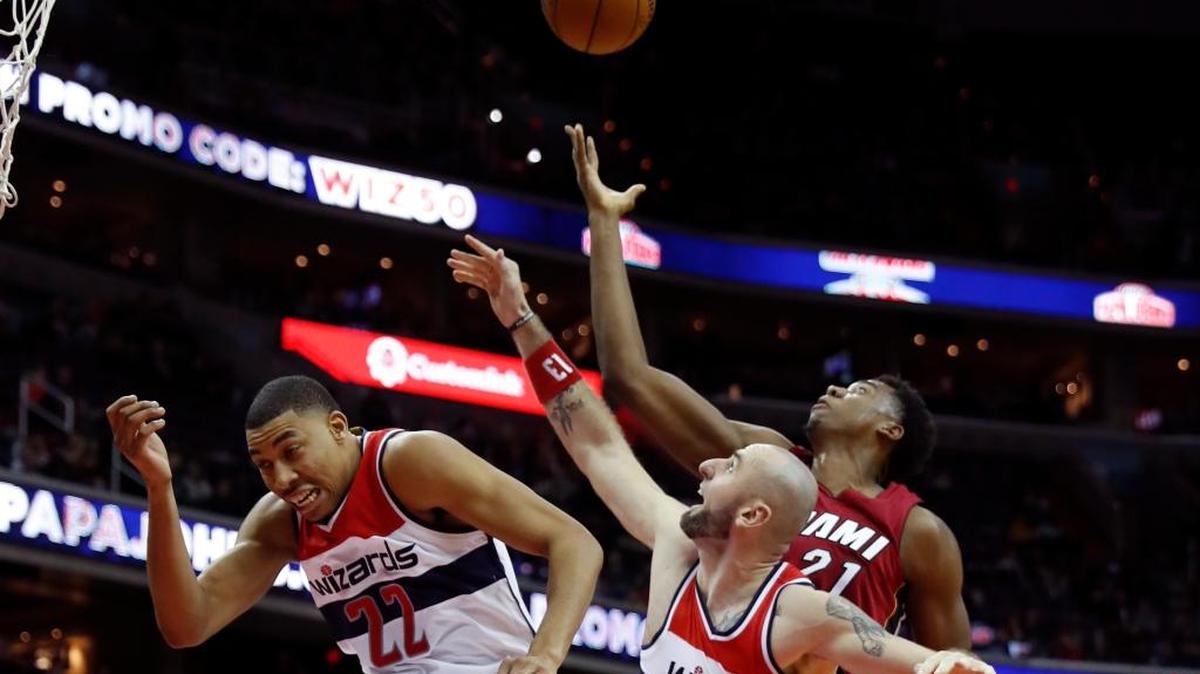 El centro del Heat Hassan Whiteside busca un rebote por encima de Otto Porter Jr. (izq.) y Marcin Gortat, de los Wizards. Whiteside este sábado facturó otro doble-doble, esta vez en Washington.