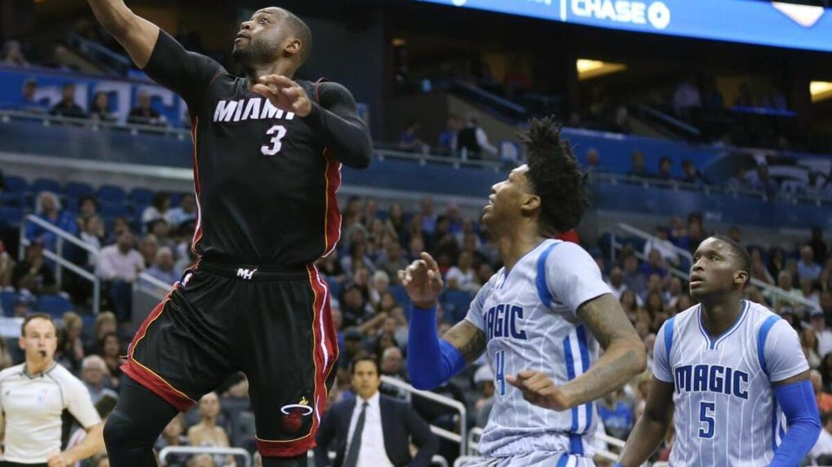 El escolta del Heat Dwyane Wade (3) penetra al aro ante Elfrid Payton (4) del magic, el viernes en Orlando.