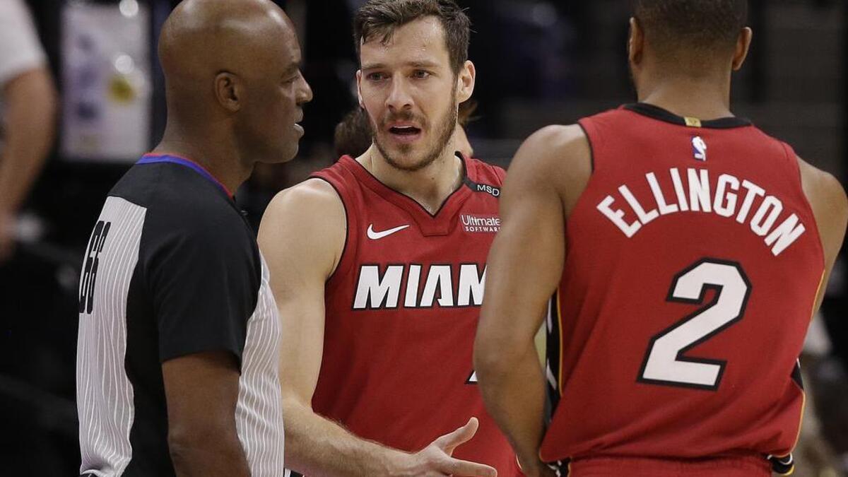 El armador del Heat Goran Dragic (centro) habla con el árbitro Haywoode Workman (izq,.) en presencia de Wayne Ellington (2) el miércoles en Sacramento.