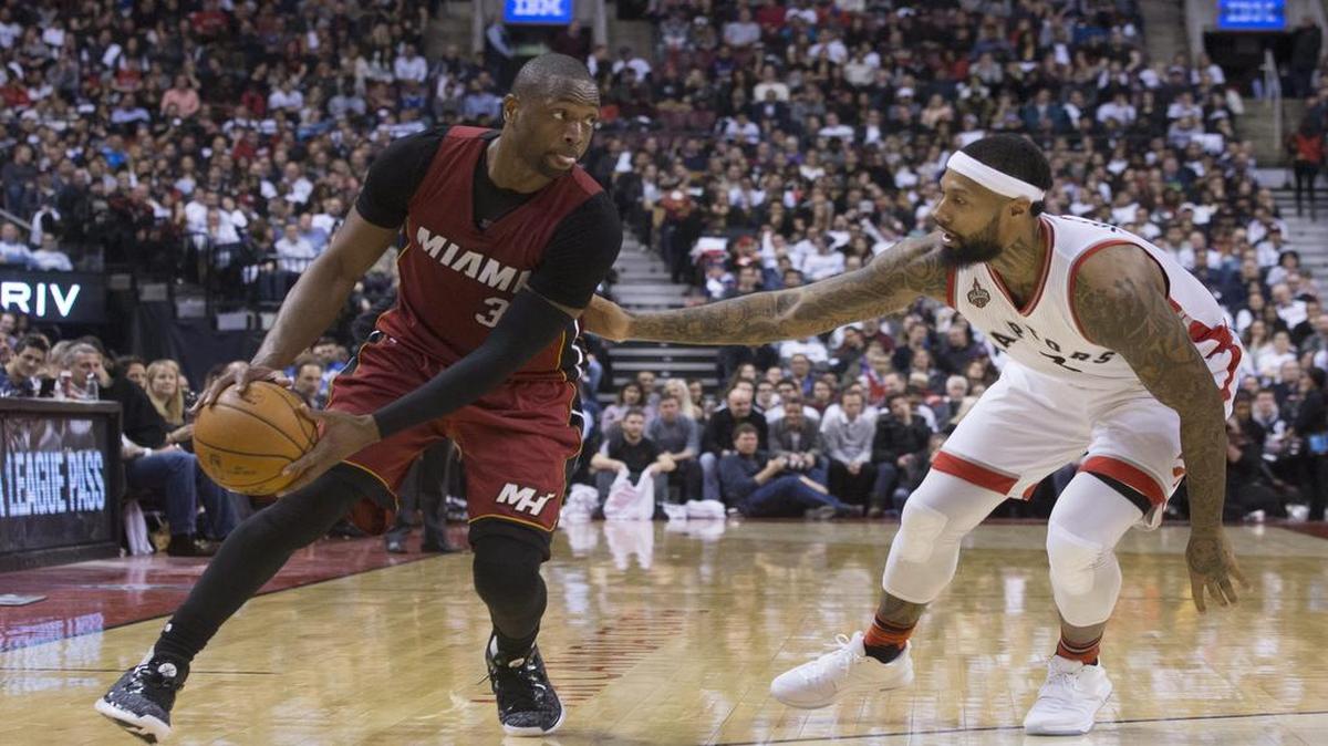 Dwyane Wade conduce la pelota por el Heat ante la marca del jugador de los Raptors James Johnson, durante el partido efectuado el 22 de enero del 2016 en Toronto.