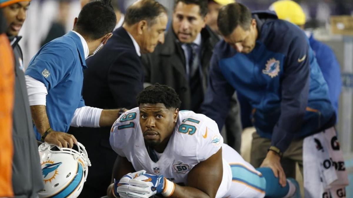 Los doctores chequean a Cameron Wake (91), de los Dolphins, luego de lesionarse en el cuarto periodo del partido contra los Patriots, en el Gillette Stadium en Foxborough, Massachusetts, la noche del jueves 29 de octubre del 2015.