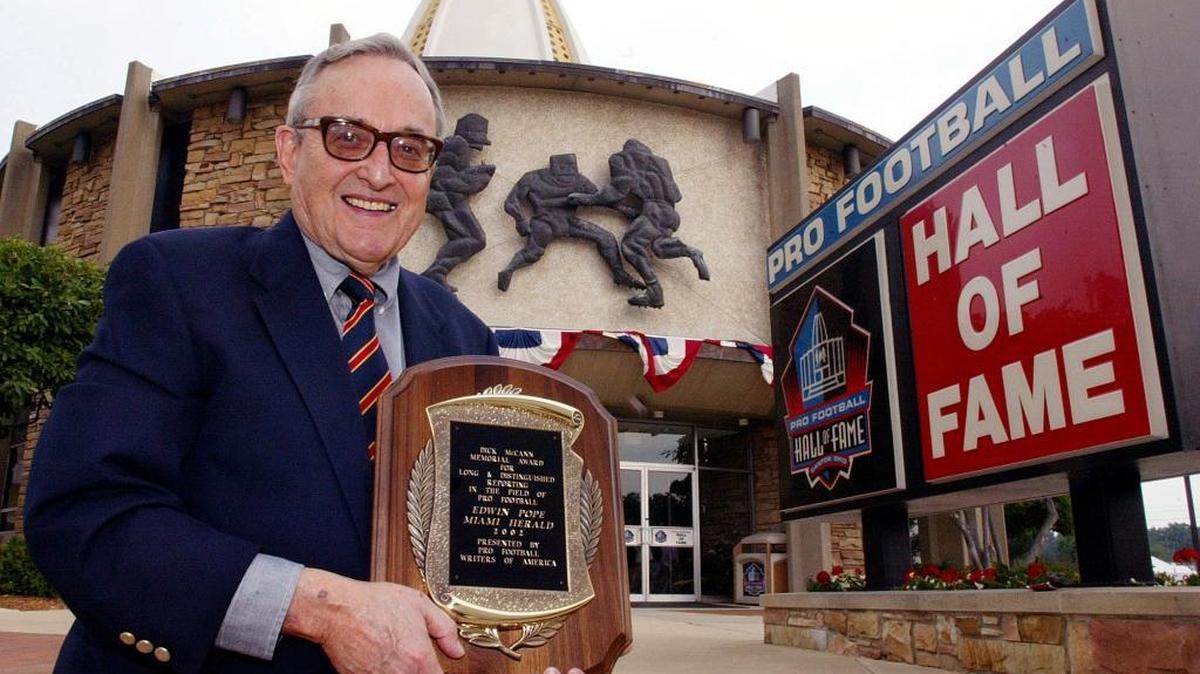 Edwin Pope posa en el Salón de la Fama del football profesional luego de ganar el Premio Dick McCamm Memorial, el 2 de agosto del 2002, en Canton, Ohio.