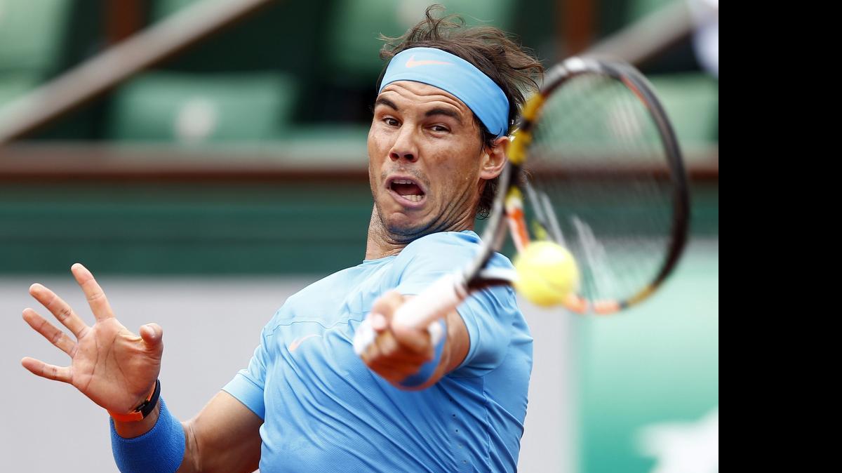 
El español Rafa Nadal golpea la bola durante su partido de la segunda ronda de Roland Garros disputado contra su compatriota Nicolás Almagro. 
