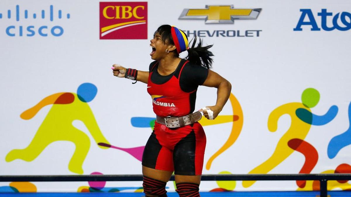 
LA COLOMBIANA Leidy Solís Arboleda celebra su triunfo en los 60 kilogramos de las pesas femeninas.

