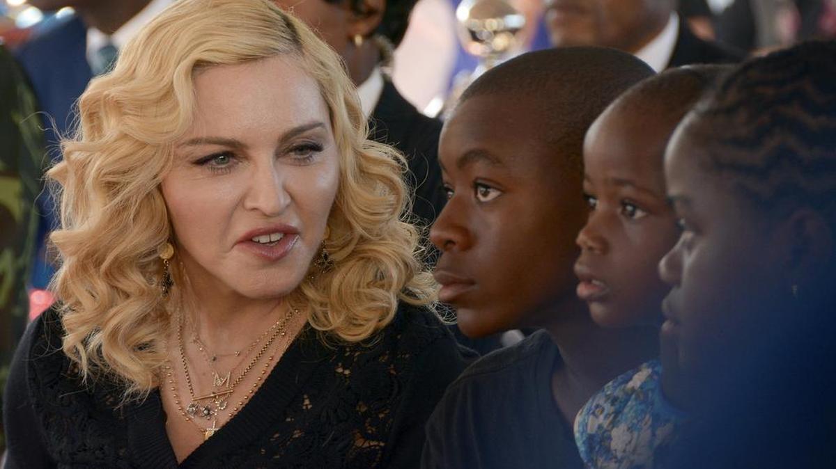 En esta foto de archivo del 11 de julio de 2017, Madonna, a la izquierda, se sienta con sus hijos adoptivos David, Stella y Mercy, en la inauguración del Instituto Mercy James de Cirugía Pediátrica y Cuidados Intensivos, ubicado en el Queen Elizabeth Central Hospital en la ciudad de Blantyre, Malawi.
