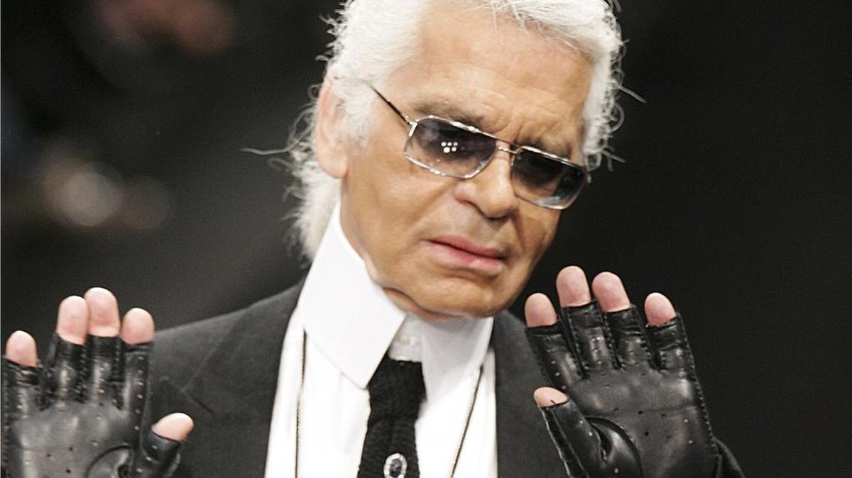 German designer Karl Lagerfeld acknowledges the audience at the end of his show for Lagerfeld Gallery during the Spring/Summer 2006 Ready-to-Wear collections in Paris, Oct. 5, 2005.
