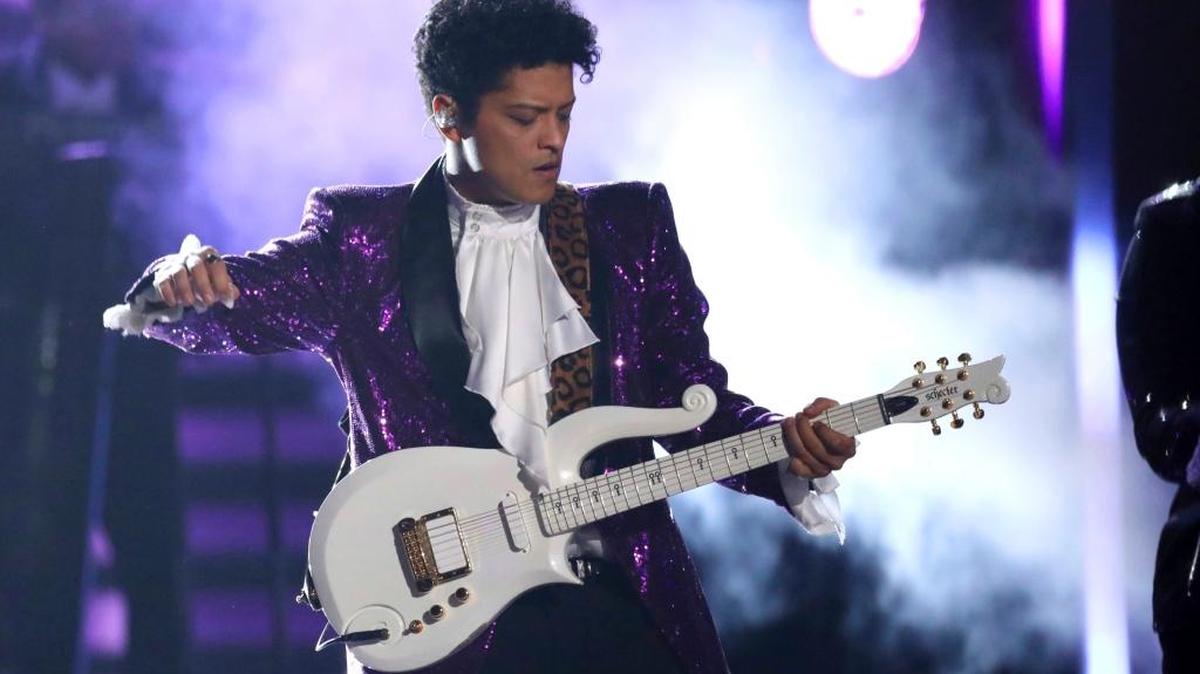 A woman was scammed out of $100,000 to a man she thought was pop singer Bruno Mars.