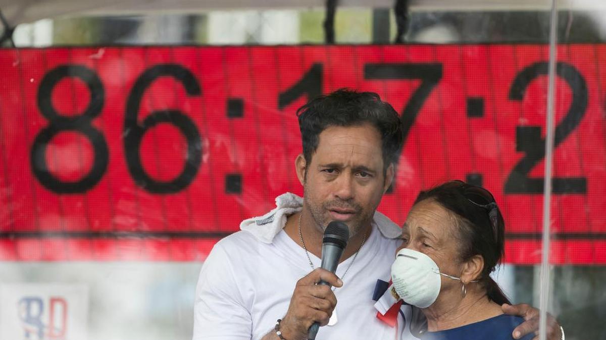 El dominicano Carlos Silver canta en una plaza pública con el fin de ingresar al libro de Récord Guinness este martes, en Santo Domingo. Silver espera cantar más de 105 horas seguidas, hazaña que inicio el viernes pasado. El récord actual lo posee el indio Sunil Waghmare, quién cantó durante cuatro días y nueve horas.