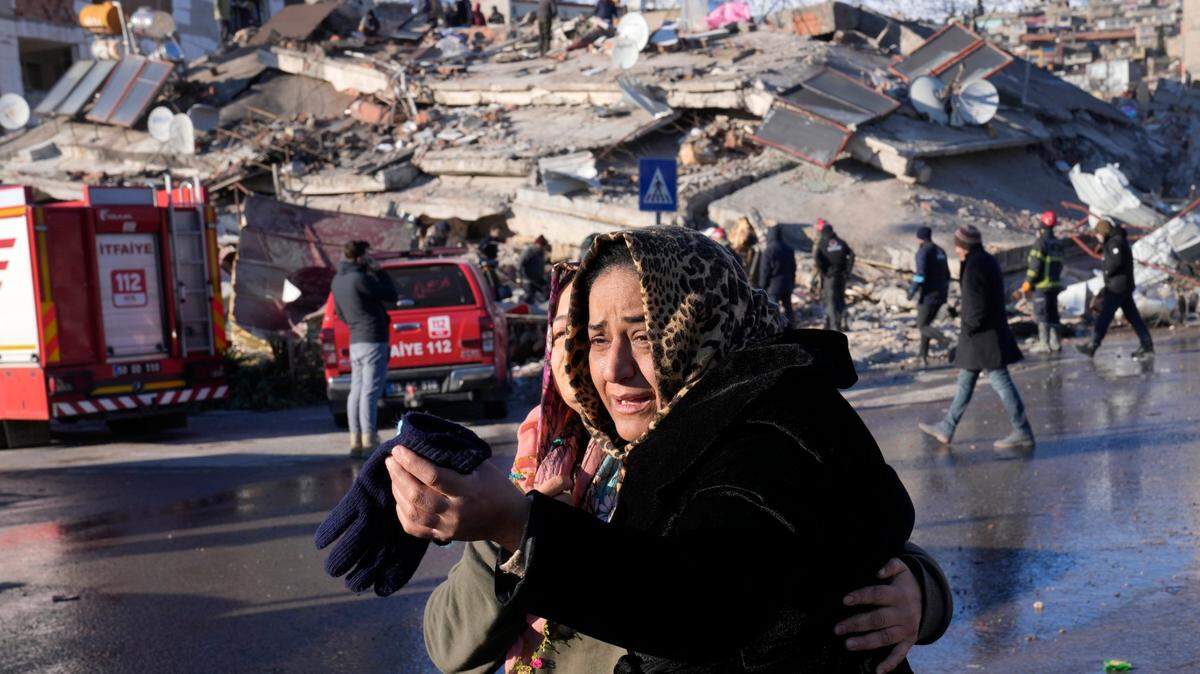 A Turkish woman weeps in front of a ruined structure on Feb. 8, 2023, part of the devastation from a 7.8 magnitude quake.