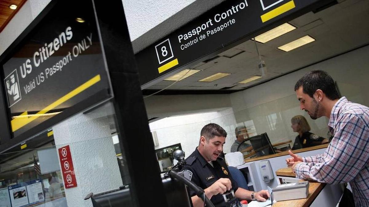 File photo shows a Customs and Border Protection (CBP) officer receiving a traveler at Miami International Airport (MIA), where stay limits for visa holders are determined upon arrival.