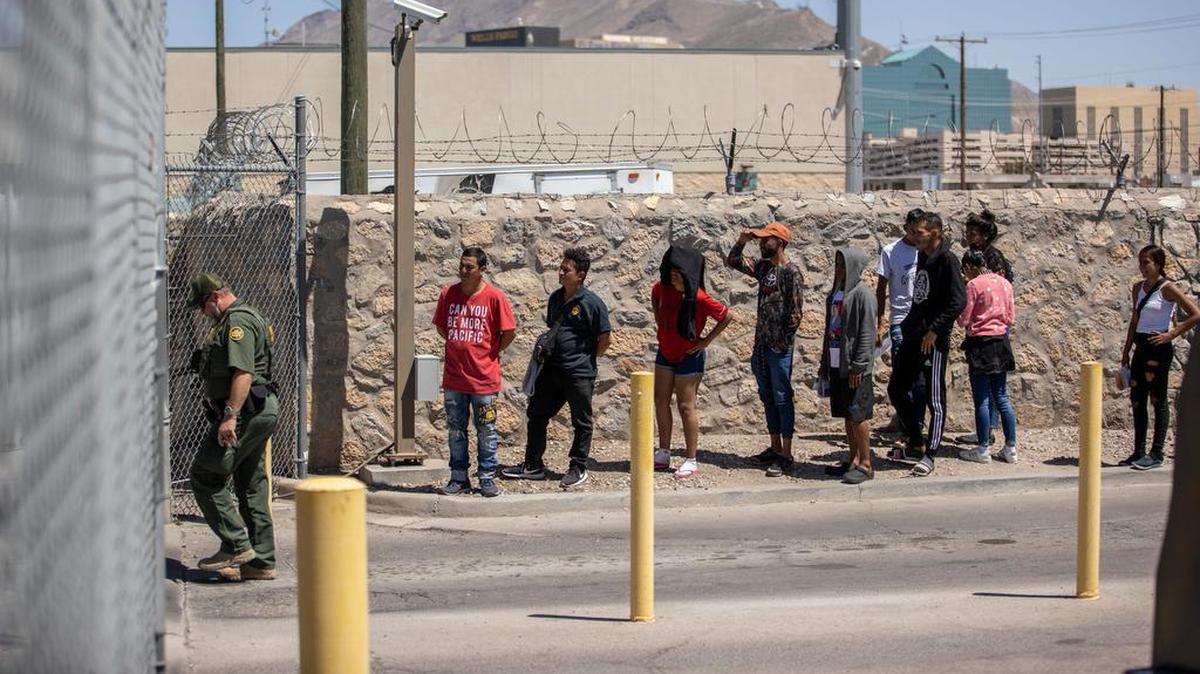 A group of migrants waits to turn themselves into U.S. Customs and Border Protection at the substation at the Paso Del Norte bridge, in El Paso, Texas, Tuesday, May 9, 2023.