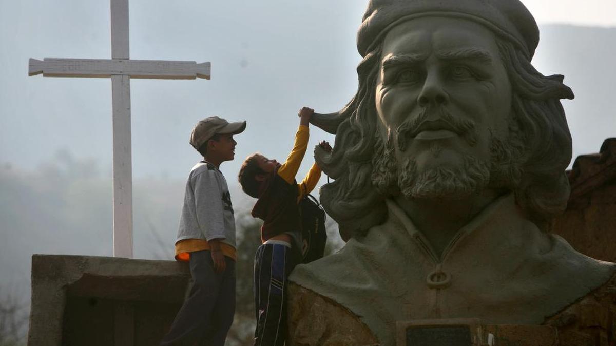 Dos niños juegan cerca de la escultura del guerrillero Ernesto Che Guevara, en La Higuera, Bolivia, el 5 de octubre de 2007.