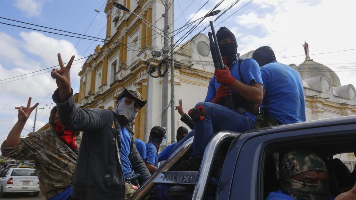 Armed pro-government militia members flash victory signs as they occupy the Monimbo neighborhood of Masaya, Nicaragua, Wednesday, July 18, 2018. On Tuesday, Nicaraguan government forces retook the symbolically important neighborhood that had become a center of resistance to Nicaraguan President Daniel Ortega’s government. (AP Photo/Alfredo Zuniga)