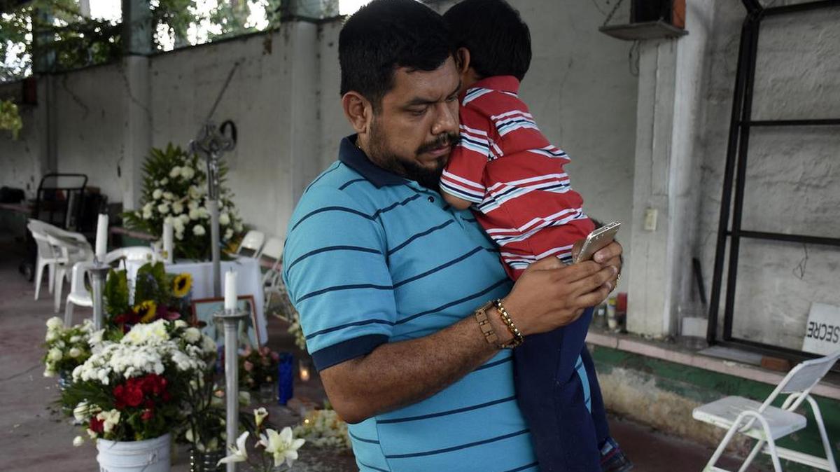 El fotógrafo mexicano Marco Gil Vera sostiene a su hijo durante una entrevista con Efe el lunes 25 de septiembre de 2017, en Jojutla, estado de Morelos, México. Marco Gil Vela saca fuerzas para buscar al soldado que rompió a llorar al hallar entre los escombros los cuerpos sin vida de la hija y esposa de este fotógrafo mexicano, desconsolado por el dolor de la tragedia del terremoto del martes pasado.