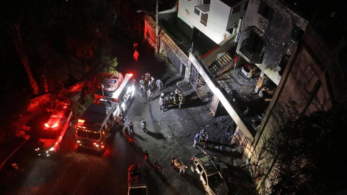 Bomberos trabajan en el lugar donde un avión monomotor se estrelló contra una residencia en los suburbios del norte de Sao Paulo, Brasil, el sábado, 19 de marzo de 2016.