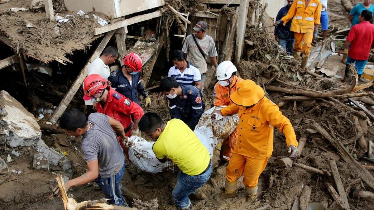 Miembros de los equipos de emergencia rescatan el cuerpo de una mujer el domingo 2 de abril de 2017, luego de una avalancha que afectó 17 barrios de la ciudad y que dejó más de 200 muertos en Mocoa, Putumayo (Colombia).
