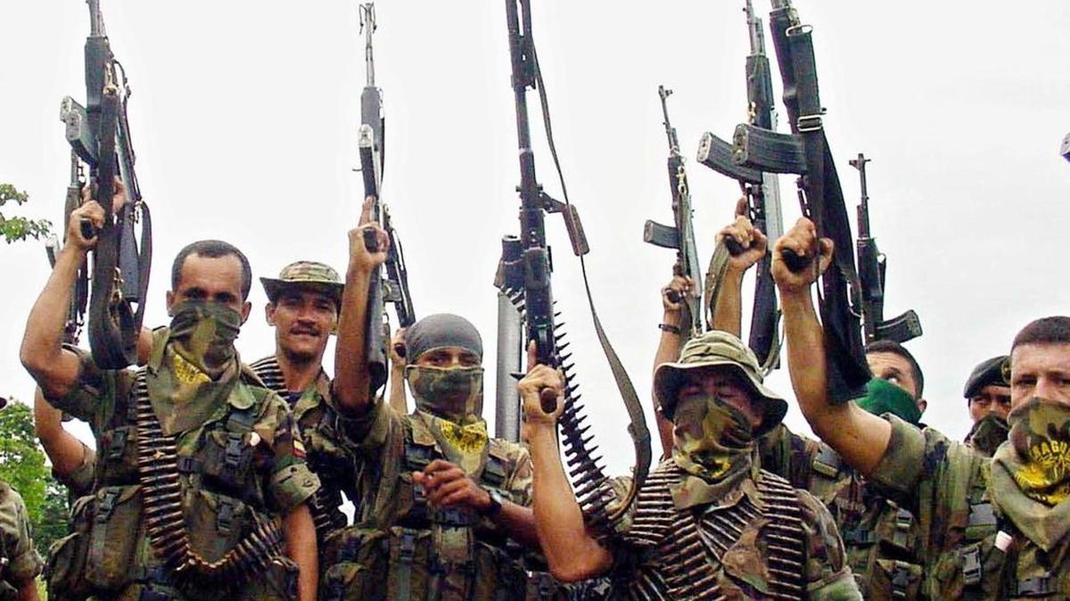 Miembros de las Autodefensas Unidas de Colombia (AUC) levantan sus armas el 14 de junio de 2001, en las montanas al norte del departamento de Santander, fronterizo con Venezuela, en Colombia.