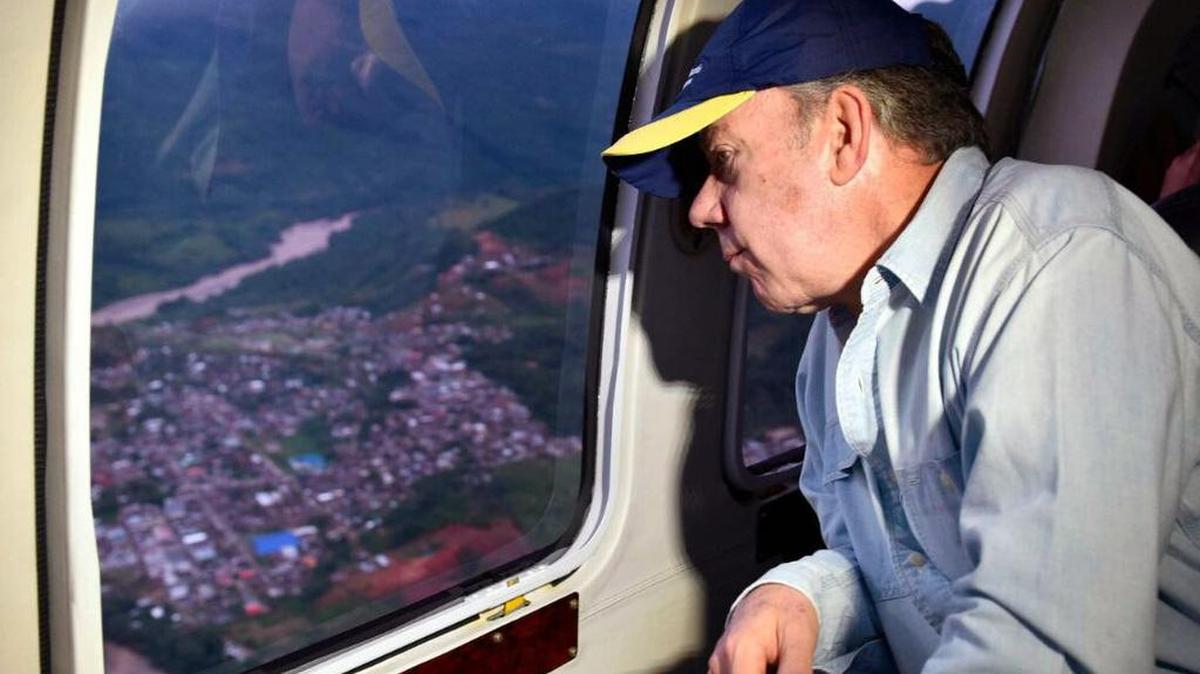 Fotografía cedida por la presidencia de Colombia del presidente de Colombia Juan Manuel Santos sobrevolando un área luego de una avalancha el sábado 1 de abril de 2017, en Mocoa (Colombia).