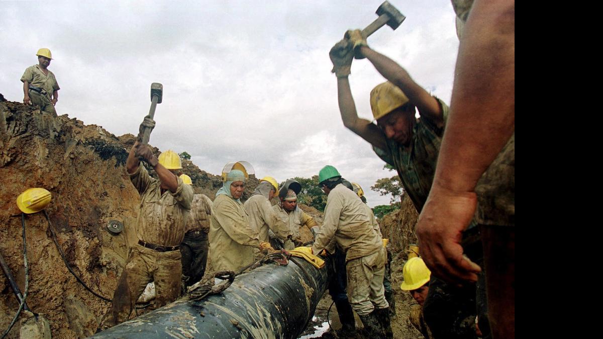 
Trabajadores colombianos intentan reparar un oleoducto que fue bombardeado por las FARC, en Arauquita, a 285 millas del noreste de Bogotá, en el 2001.
