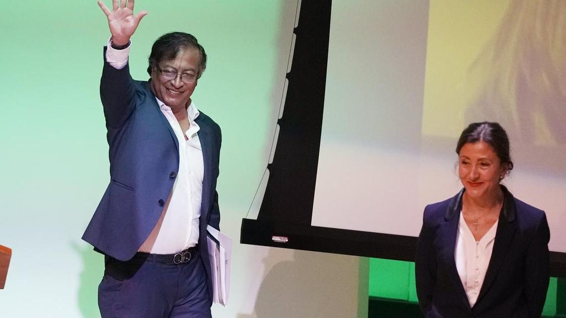Presidential candidate Gustavo Petro with the Historical Pact coalition waves as presidential candidate Ingrid Betancour with the Green Oxygen Party smiles, before the start of a presidential debate at the Externado University in Bogota, Colombia, Tuesday, March 29, 2022, ahead of the May 29 election.