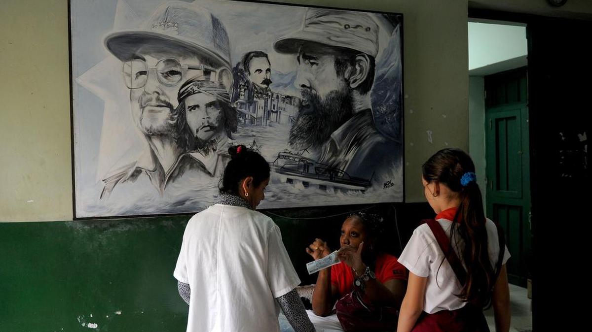 A framed drawing of Fidel Castro with brother Raúl, at left, and other Cuban Revolutionary leaders hangs in a Havana school in 2017.