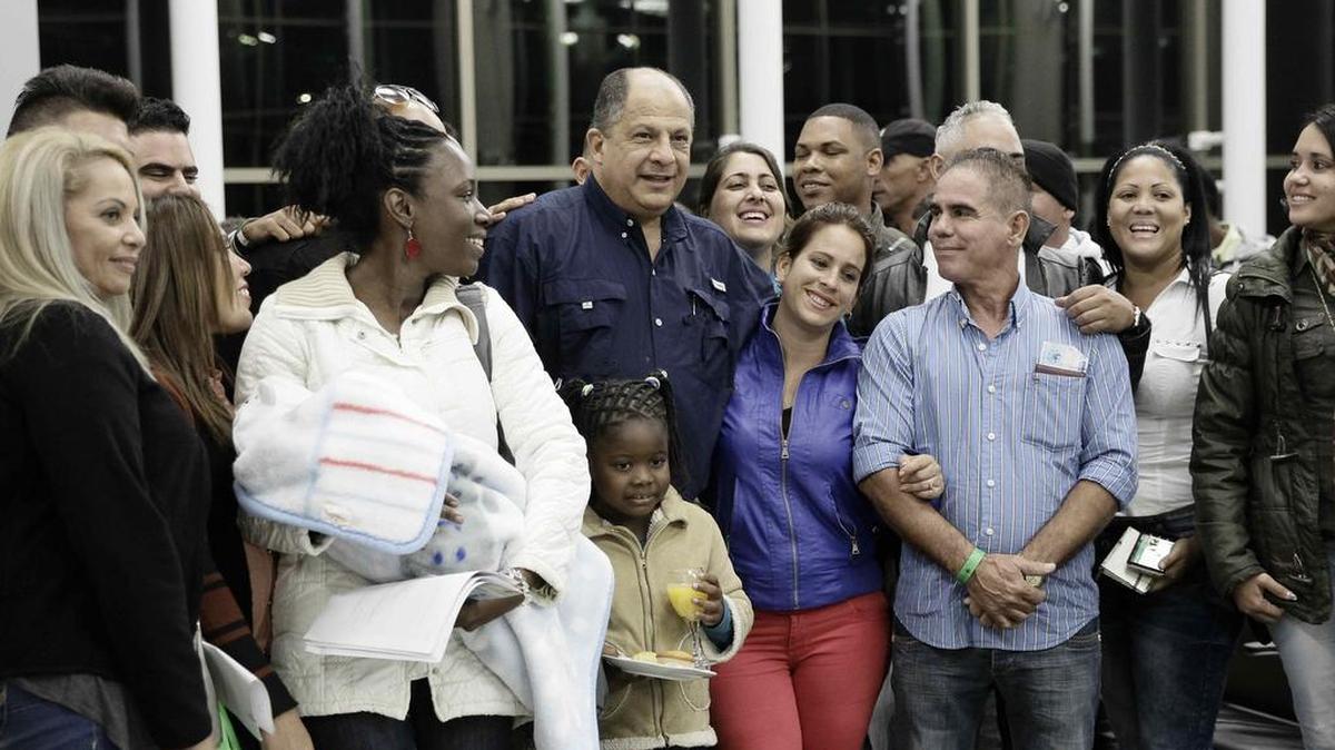 El presidente de Costa Rica Luis Guillermo Solís (c) posa hoy, viernes 11 de marzo de 2016, con un grupo de cubanos que viajan hacia Nuevo Laredo, México, en su ruta para los Estados Unidos, en el aeropuerto Juan Santamaría en San José (Costa Rica).