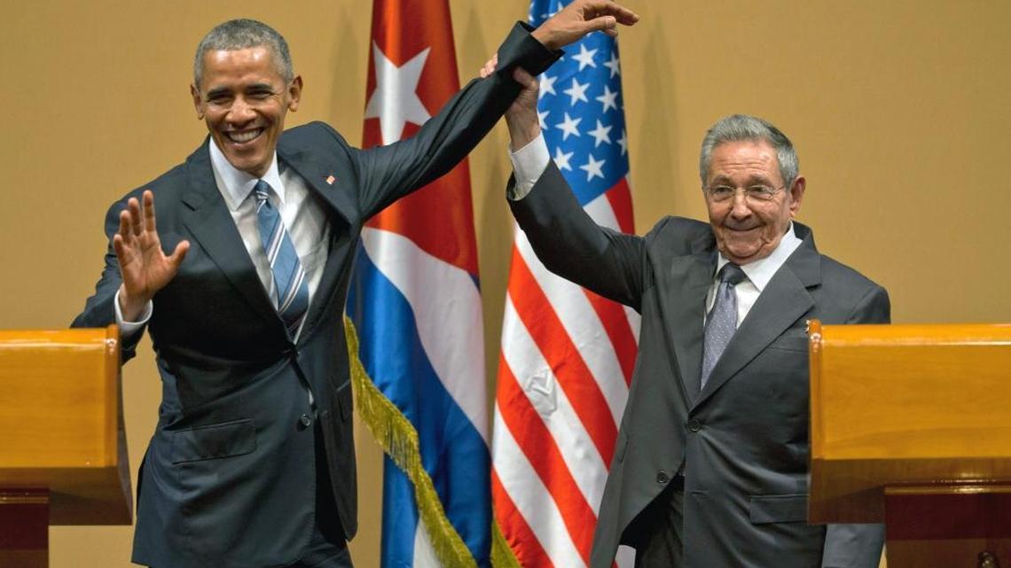 In this March 21, 2016, file photo, Cuban President Raul Castro, right, lifts up the arm of President Barack Obama, at the conclusion of their joint news conference at the Palace of the Revolution, in Havana, Cuba. Obama was joined by wife Michelle Obama and daughters Malia and Sasha in the first visit by a sitting president to the island nation in 88 years. 