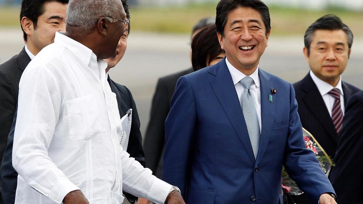 El primer ministro de Japón, Shinzo Abe, es recibido por el vicepresidente cubano, Salvador Valdéz Mesa (izq.) .