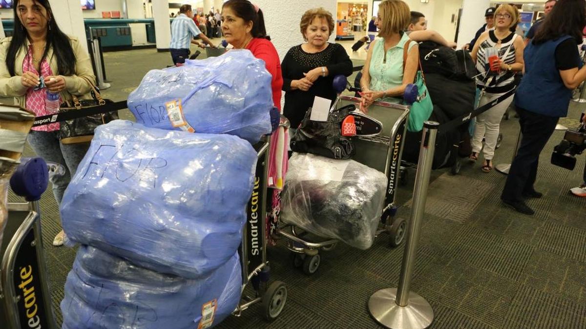 A group of Cuban travelers wait for their flight to the island at Miami International Airport in 2015. File photo.