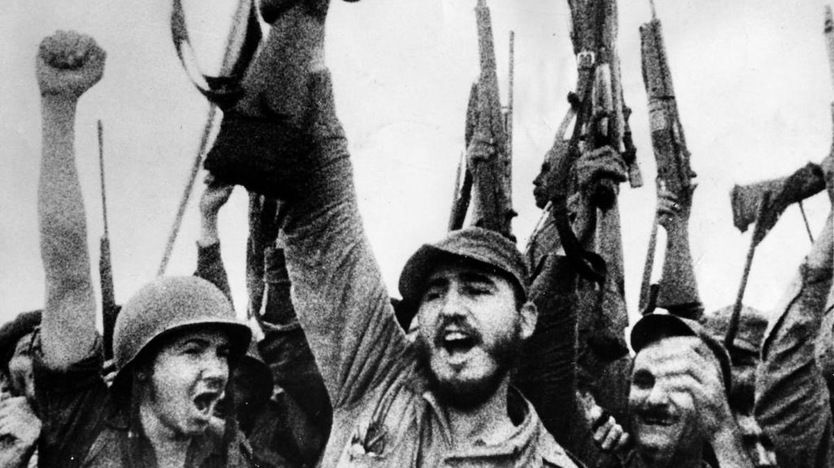 Cuban Revolution leader Fidel Castro, center, celebrates the triumph of the rebellion over the regime of Fulgencio Batista in 1959 with younger brother and second-in-command Raúl, at left.