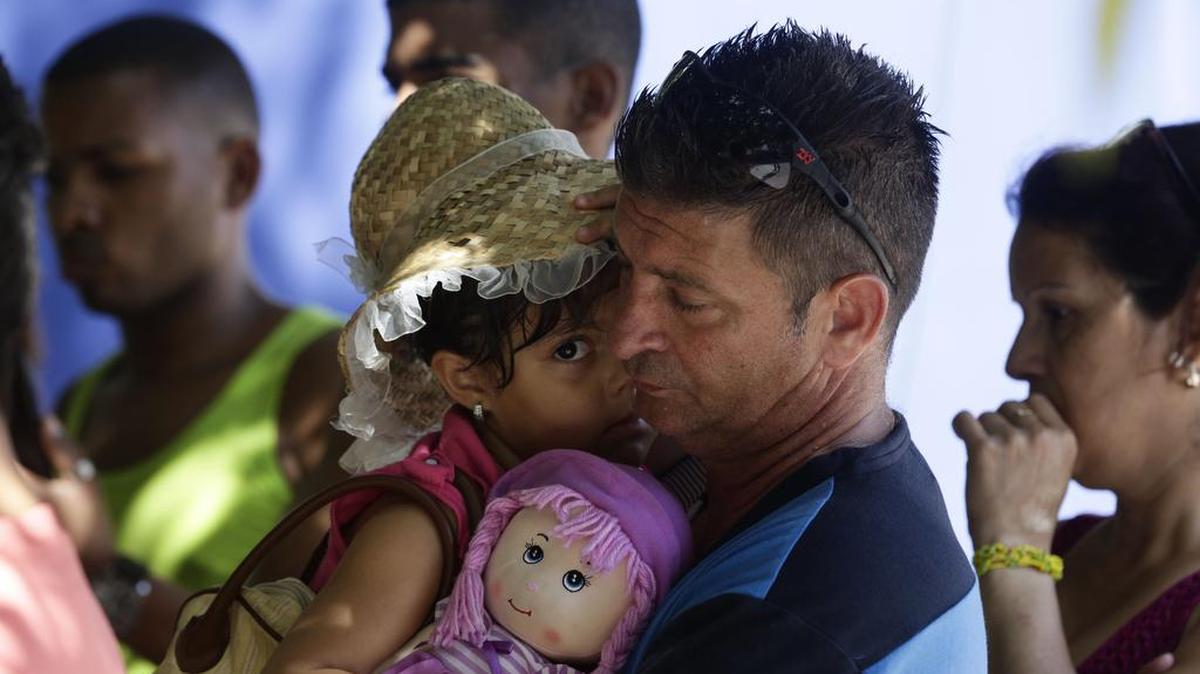 El migrante cubano Denis Gómez, de 45 años, junto a su hija Dalia Caridad, de 4 años, en la ciudad de Panamá. Gómez es uno de los miles que quedó atrapado sorpresivamente rumbo a EEUU, por la decisión de Barack Obama de terminar con la política de pies secos, pies mojados.