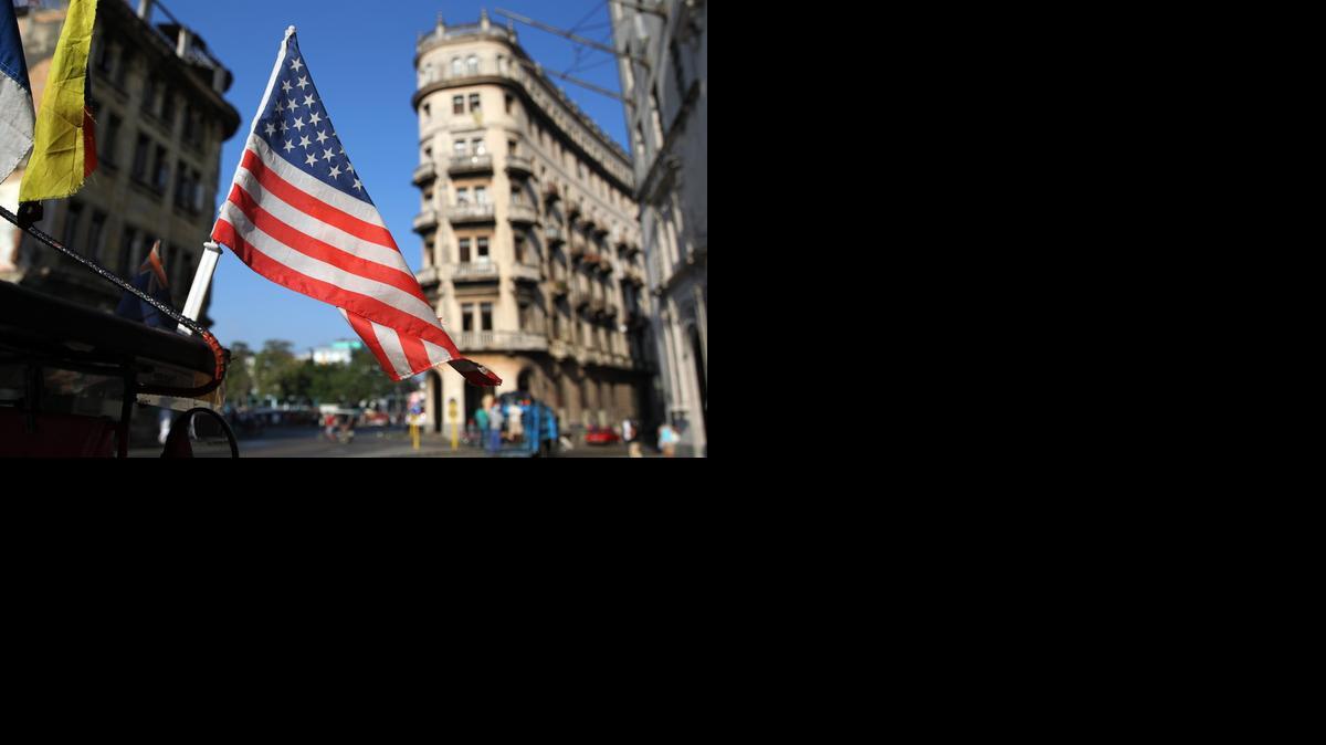 
 Una bandera de Estados Unidos ondea sobre un bicitaxi, el miércoles 15 de abril de 2015, en una calle de La Habana (Cuba).  
