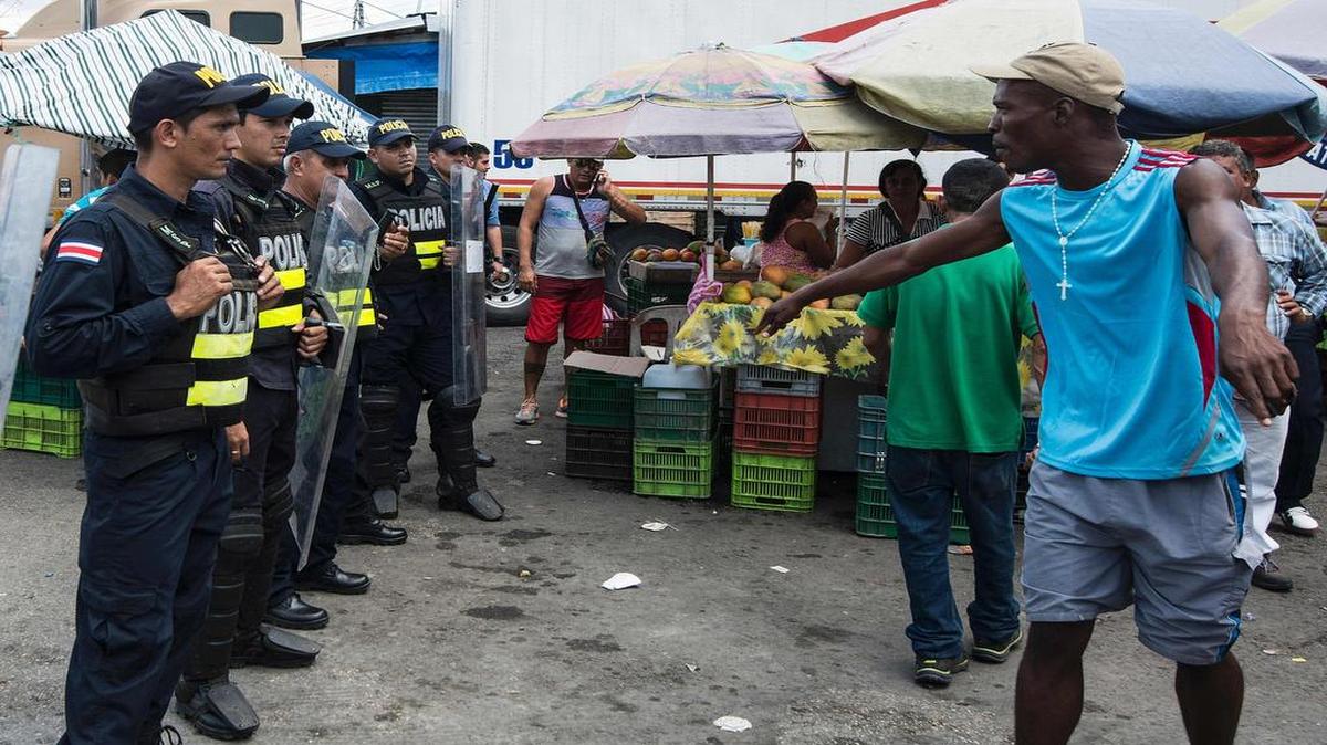 Un inmigrante cubano protesta frente a efectivos de la policía de Costa Rica, que le bloquean el paso en la frontera con Panamá, este jueves 14 de abril.