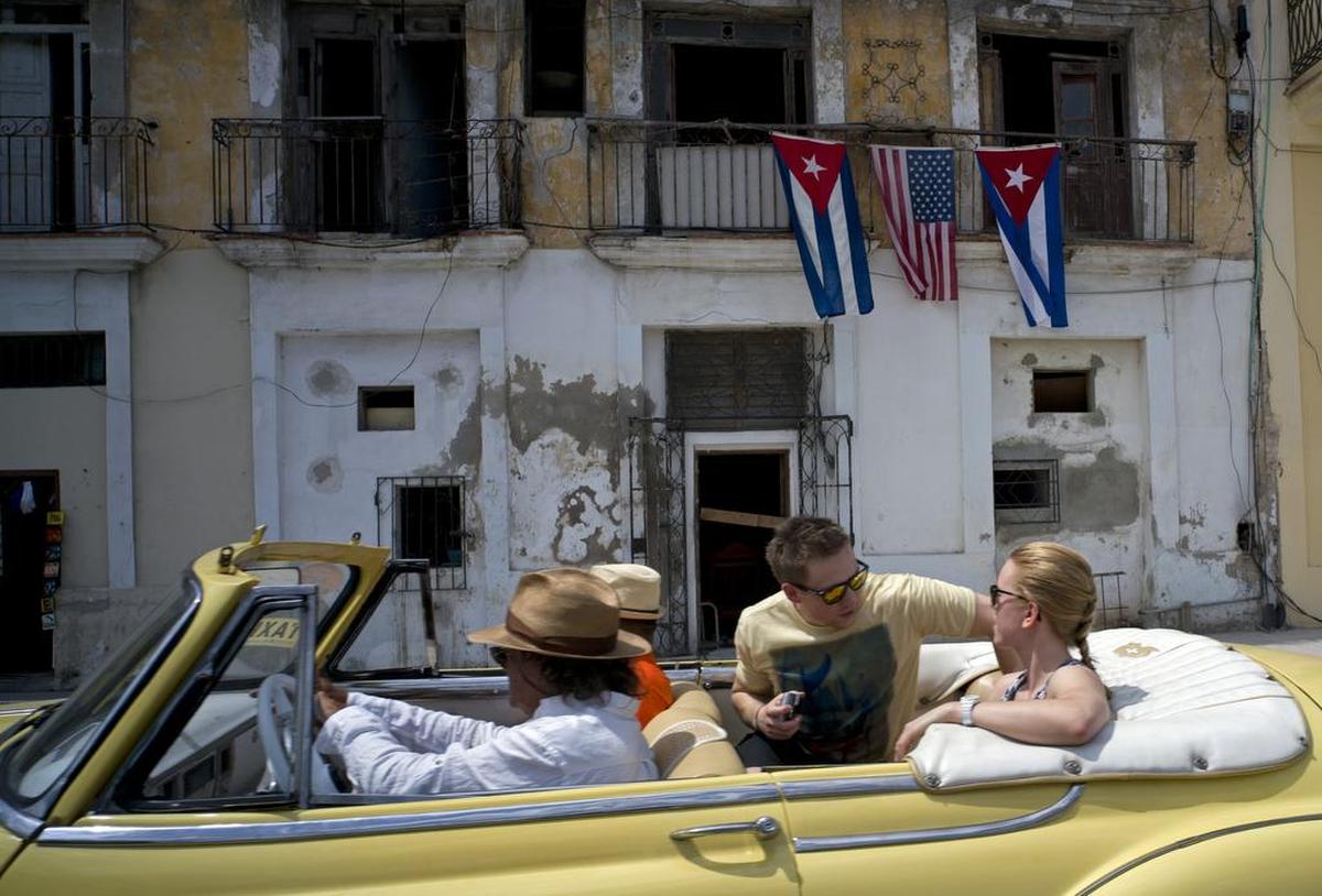Cruising in Havana in an ancient automobile.