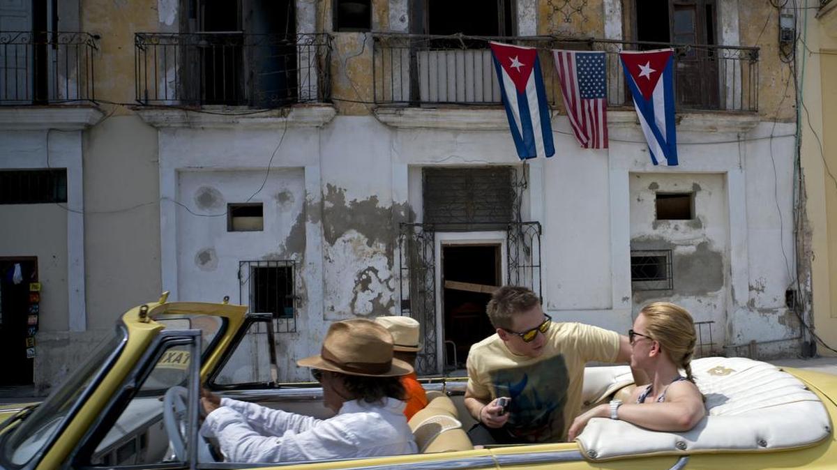 Cruising in Havana in an ancient automobile.