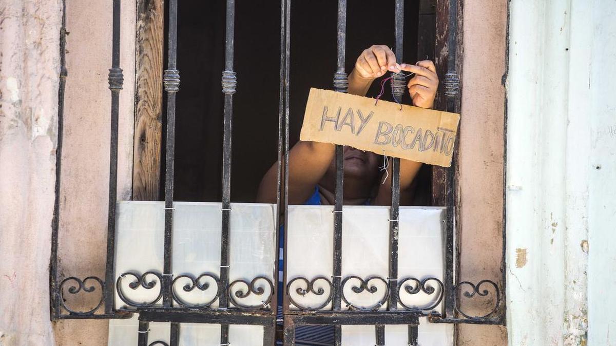 Some cuentapropista operations are small. Here a woman places a sign  in the doorway of her home that advertises “bocadito” (snacks) are for sale.